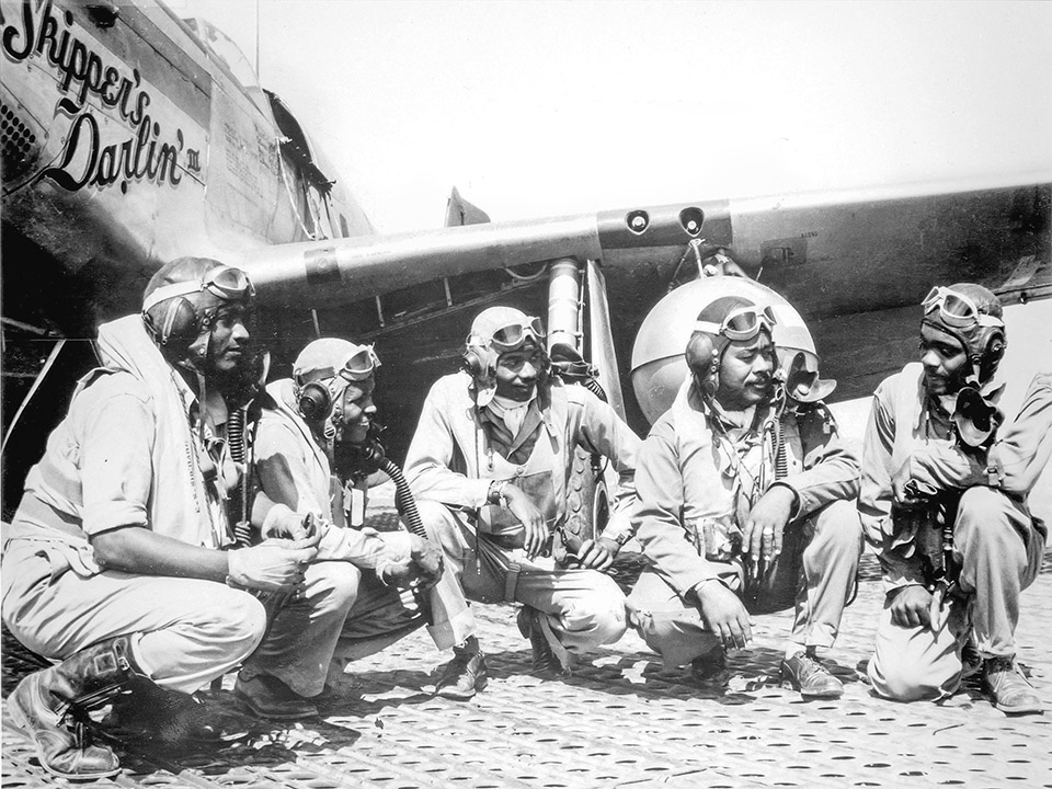 Pilots of the 332nd Fighter Group, "Tuskegee Airmen," the elite, all-African American unit, pose at Ramitelli, Italy: (from left to right) Lt. Dempsey Morgan, Lt. Carroll Woods, Lt. Robert Nelson Jr., Capt. Andrew D. Turner, and Lt. Clarence Lester.